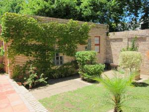 a brick building with ivy growing on it at EdenNook in George