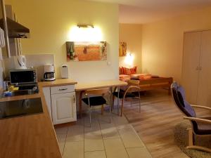 a kitchen and living room with a table and chairs at Flensburg Ferienwohnungen Apartment 2 in Flensburg