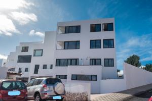 two cars parked in front of a white building at Loft del Mar 2 Jandia in Playa Jandia