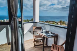 a balcony with a table and chairs and the ocean at Loft del Mar 2 Jandia in Playa Jandia