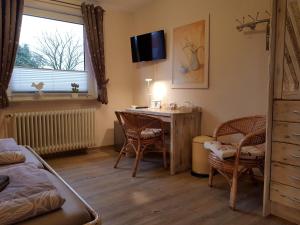 a bedroom with a bed and a table and chairs at Gästehaus Flensburg Engelsby in Flensburg