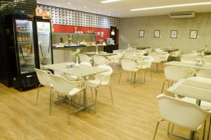 Um restaurante ou outro lugar para comer em Ímpar Suítes Expominas