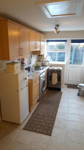 a kitchen with a stove and a dishwasher at Silver Ridge, 2 House O` Hill in Newton Stewart