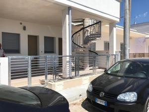 a black car parked in front of a house at Salsedine in Porto Cesareo