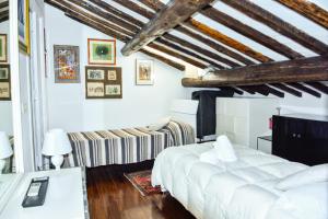 1 dormitorio con cama blanca y sofá en AltanaParlamento, en Roma