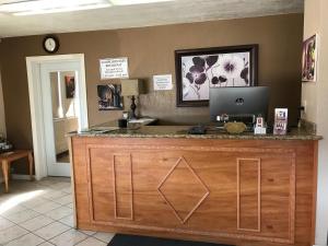 a counter with a laptop on top of it at Vino Inn & Suites in Atascadero