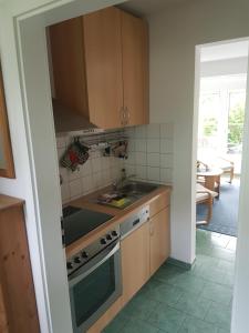 a kitchen with a sink and a stove top oven at Ferienhaus Zinnowitz in Zinnowitz