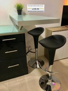 TV a/nebo společenská místnost v ubytování Tiny Apartment LIVE-IN Wertheim am Main