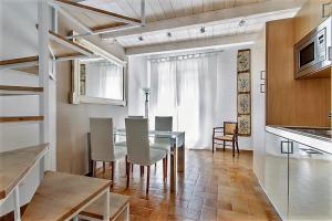 a kitchen and dining room with a table and chairs at Penthouse Luxury Quattro Canti in Palermo