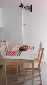 a table with two chairs and a table with a blanket on it at Casa Le Cementine in Verbania +2 photos