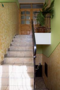 a staircase in a house with a potted plant at Penzion Zelený Dvor in Veľká Lomnica