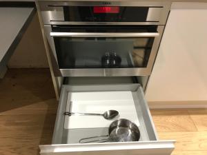 a kitchen with two pots and pans in a drawer at The Annex in Ickenham