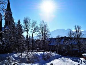 a church with a clock tower in the snow at VIP Apartamenty KRUPÓWKI in Zakopane