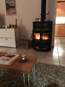 a living room with a wood stove in a room at Penthouse Apartment - Sez Ner in Obersaxen