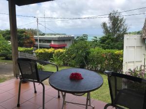 a table and chairs on a patio with a view of a yard at Room With A View & Apartment Style in Port Vila