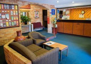 a waiting room with two chairs and a table at Windsor Terrace Motel in Windsor