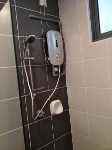 a shower in a bathroom with a soap dispenser on the wall at Non Smoking Theda Evo Soho Bangi with Coway & Wifi - Pool Tutup in Bangi
