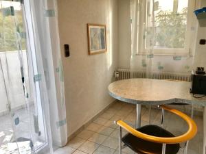 a kitchen with a table and two chairs and a window at Gästehaus Kaiser in Ostfildern +62 photos