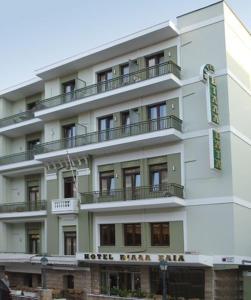 a tall white building with balconies on it at Villa Elia in Veria
