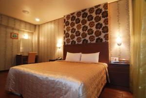 蘆竹區的住宿－貝克漢汽車旅館 ，一间卧室,卧室内配有一张大床
