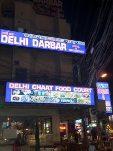 a sign for a deli chain food court on a building at Hari Om Delhi Darbar in Pattaya