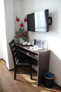 a desk with a chair in a room at KL Hotel in Labuan