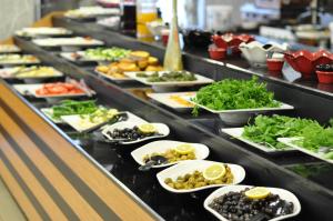a buffet line with many plates of food at Double Comfort Hotel in Ankara