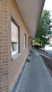 a brick building with a sidewalk next to a window at Heinsberg City in Heinsberg
