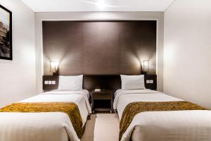 Cama o camas de una habitación en Tasneem Convention Hotel Yogyakarta