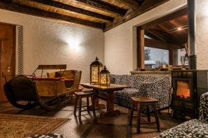 a living room with a couch and a table and a fireplace at Hotel Vallecetta in Bormio