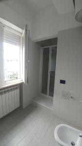 a white bathroom with a shower and a sink at B&b I portici in Catanzaro