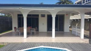 a house with a patio with a swimming pool at "Hanikea" Quiet & Pool Home in Papeete