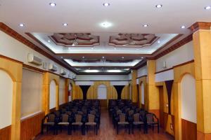 an empty room with chairs in a building at Hotel Vasundhara Palace in Rishīkesh