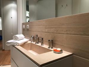 a bathroom with a sink and a mirror at Apartment San Domenico in Siena +26 photos
