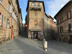 an alley in an old city with a building at Apartment San Domenico in Siena