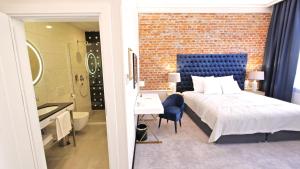 a bedroom with a large bed and a bathroom at SZEWSKA 22 BOUTIQUE in Krakow