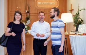 eine Gruppe von drei Personen, die in einem Zimmer stehen in der Unterkunft Hotel Alter Wirt in Hallbergmoos