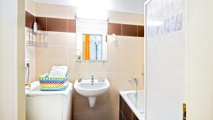 a bathroom with a sink and a toilet and a mirror at Central Apartmany Biela street in Bratislava