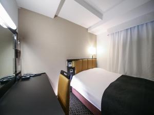 a hotel room with a bed and a desk at APA Hotel Sugamo Ekimae in Tokyo