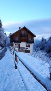 a house covered in snow in front at Le Haut Van in Fraize