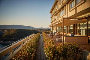 a building with a row of plants on a balcony at Shima Kanko Hotel The Classic in Shima