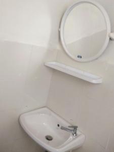 a bathroom with a sink and a mirror on the wall at Hutyee Boat Bungalow in Ko Lanta