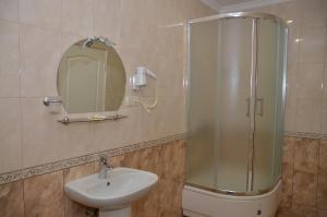 a bathroom with a shower and a sink and a mirror at Zatyshok Затишок in Rokytne +31 photos