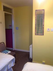 a room with two beds and a mirror on the wall at Hill View B&B in Silvermines