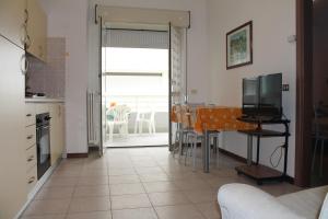 アルバ・アドリアティカにあるAppartamenti Stella Marinaのリビングルーム(テレビ付)、キッチン(テーブル付)