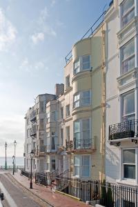 a building with balconies on the side of a street at Hamptons Brighton in Brighton & Hove