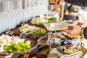 a person is serving food at a buffet at Sinema Hotel Ordu in Ordu