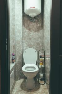 a bathroom with a toilet with a light above it at Prime Home in Chernihiv