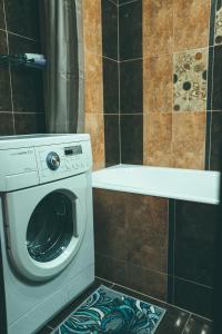 a washer and dryer in a bathroom at Prime Home in Chernihiv