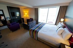 a hotel room with a bed and a large window at Holiday Inn Southend, an IHG Hotel in Southend-on-Sea